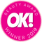 Rosafarbenes Badge mit der weißen Aufschrift „OK! Beauty Award Winner 2019“ und einem Zickzack-Rand.