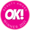 Rosafarbenes Abzeichen mit der Aufschrift „OK! Beauty Award Winner 2021“ in weißer Schrift und einem Zickzack-Rand.