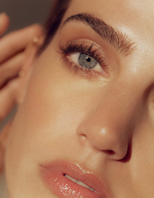 Nahaufnahme des Gesichts einer Frau mit blauen Augen und gepflegten Augenbrauen, die mit dem Hi-Def Brow Pencil von RevitaLash® Cosmetics definiert wurden.