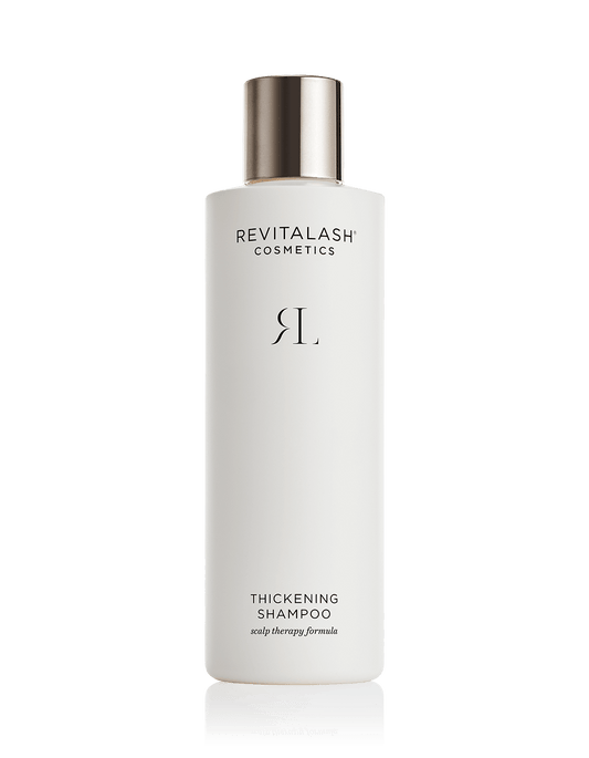 Eine weiße Flasche RevitaLash® Cosmetics Thickening Shampoo mit silbernem Deckel.